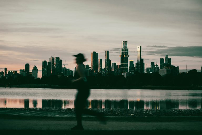 Person running past a city skyline